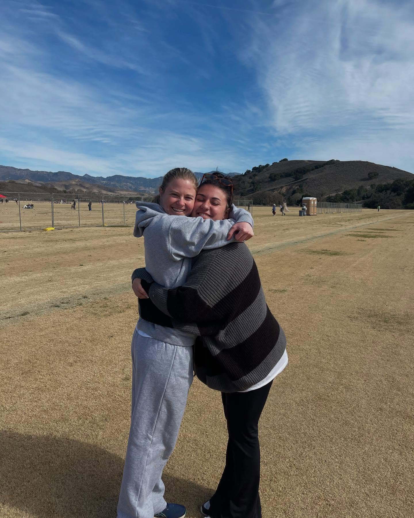 Two Northern Arizona University Women’s Lacrosse Club teammates hugging at the 2025 Santa Barbara Shootout
