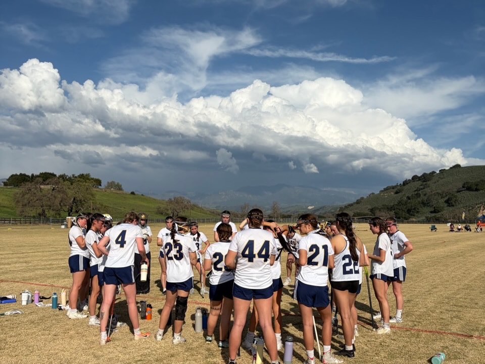 NAU Women’s Lacrosse Club players gathered in a team huddle