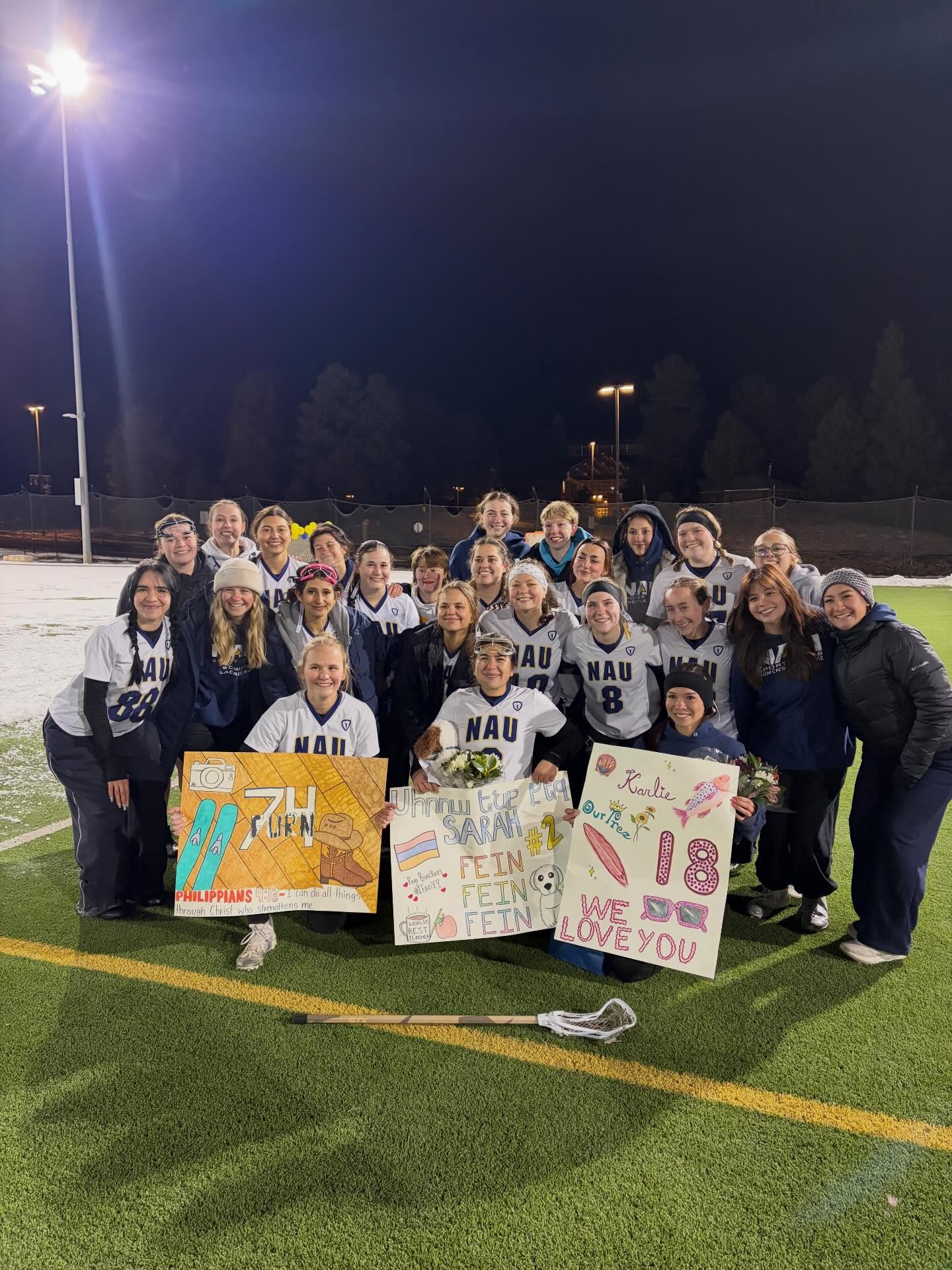 Northern Arizona University Women’s Lacrosse Club team together on a snowy field in Flagstaff